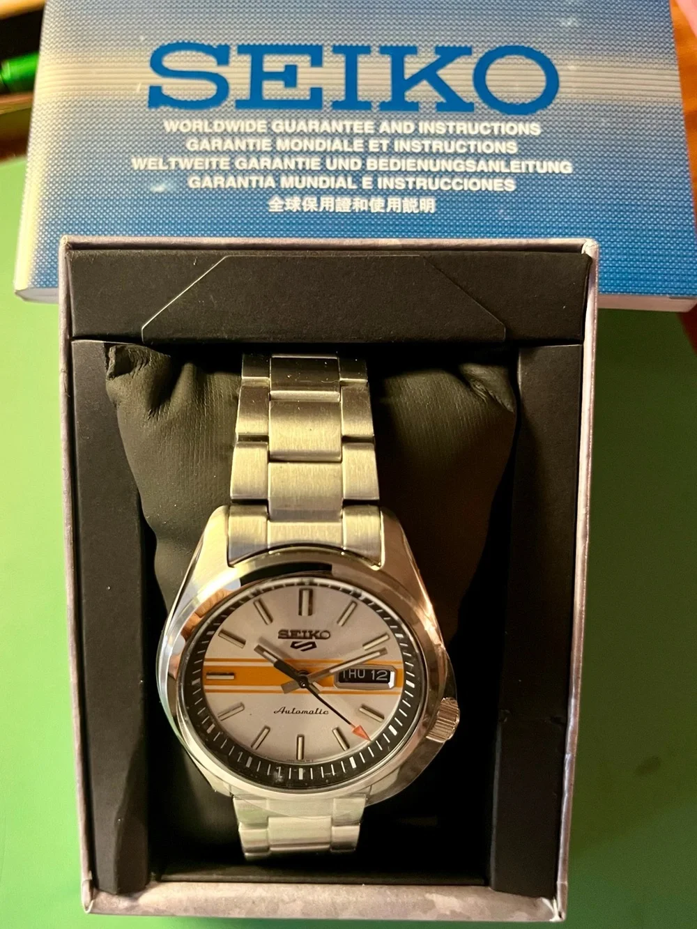 Seiko : Retro GT dial. Silver Dial Watch with Orange Stripe Accent SRPE55